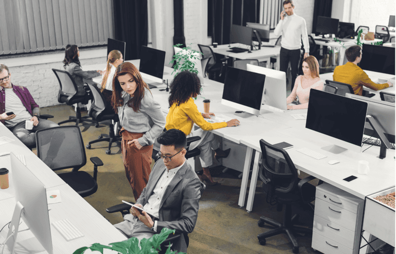 high angle view of young multiethnic businesspeople working with digital devices in open space